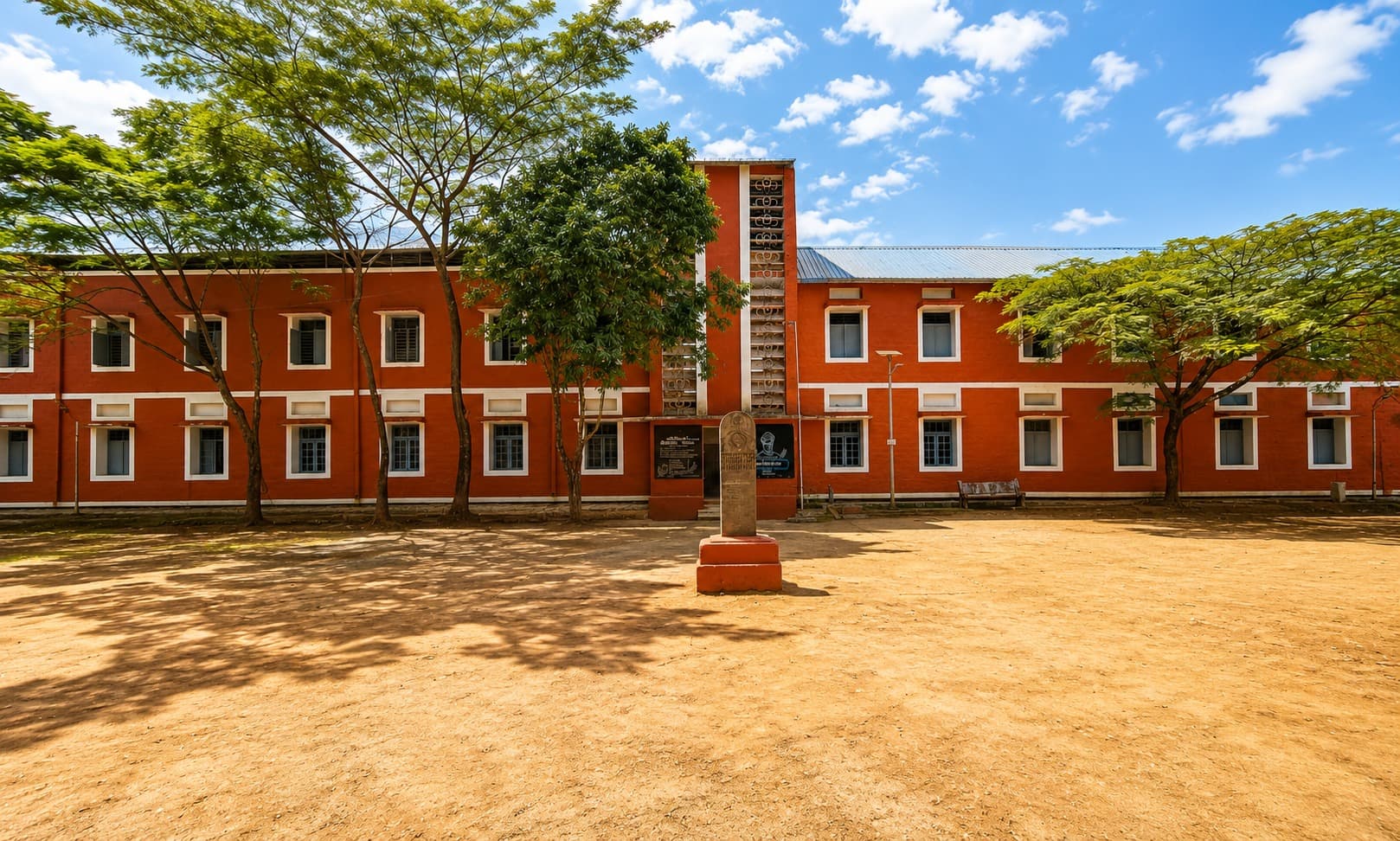 Classroom block — repainted facade with a memorial plaque