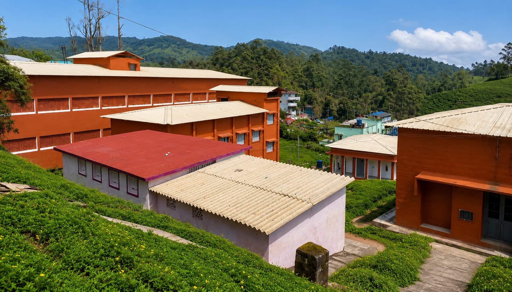 Roofscape — new corrugated roofing across the campus, hills beyond