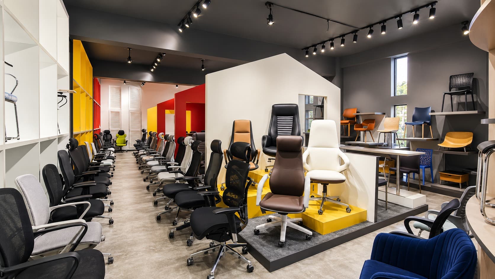 Showroom — premium seating display beneath a house-shaped volume